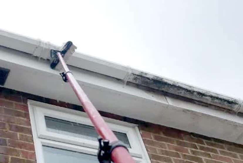 Reaching the high runs safely with the gutter vac pole.