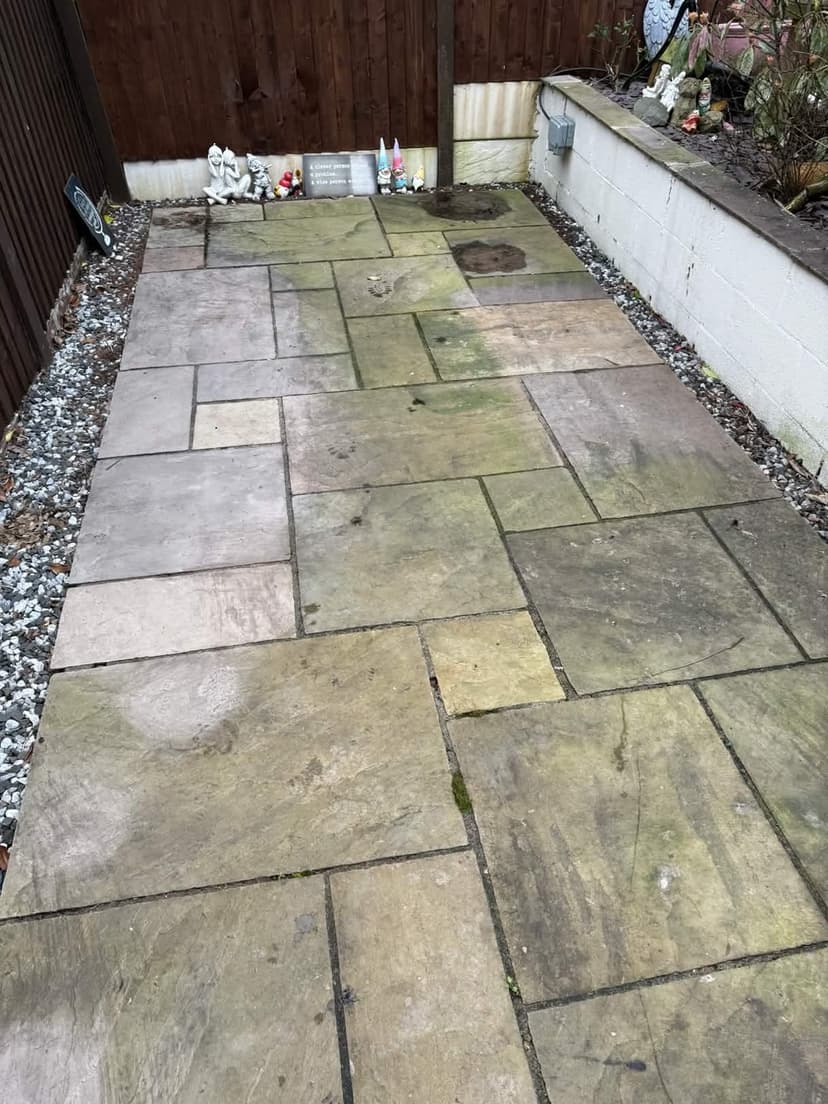Before — the same patio under green algae and ingrained dirt.