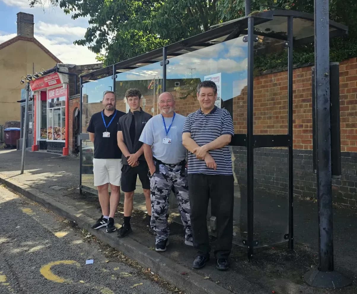 James of Whales Exterior Cleaning standing with Thrapston Town Council staff at the town bus stop he cleaned free of charge