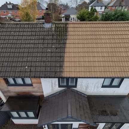 Halfway through — one side cleaned, one side still under moss. Same roof.